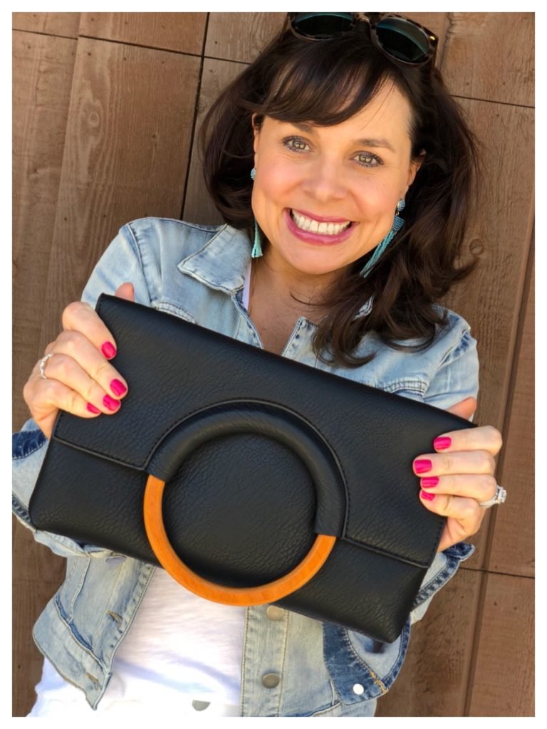 black clutch with wooden ring